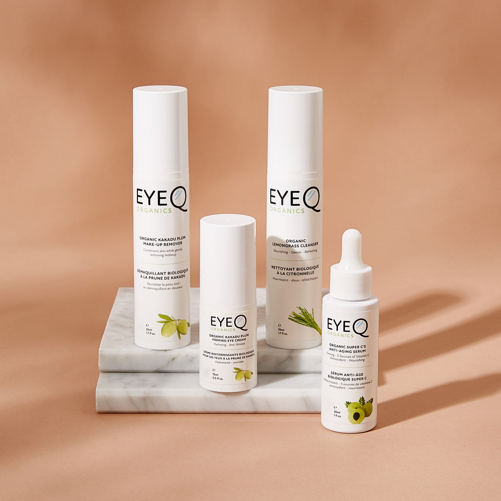 EyeQ Botanics skincare products on a marble stand with a warm brown background. You’ll receive 
one of each 30ml Organic Super C Anti-Aging Serum, 15ml Organic Kakadu Plum Firming Eye Cream, 50ml Organic Kakadu Plum Make-up Remover, 50ml Organic Lemongrass Cleanser